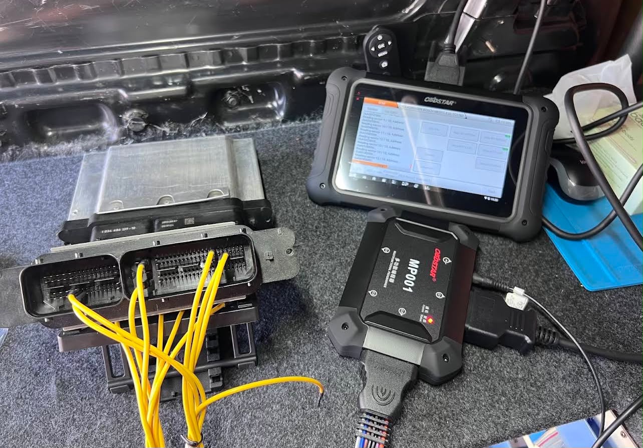 Two ECUs on a bench being cloned with a programming tool